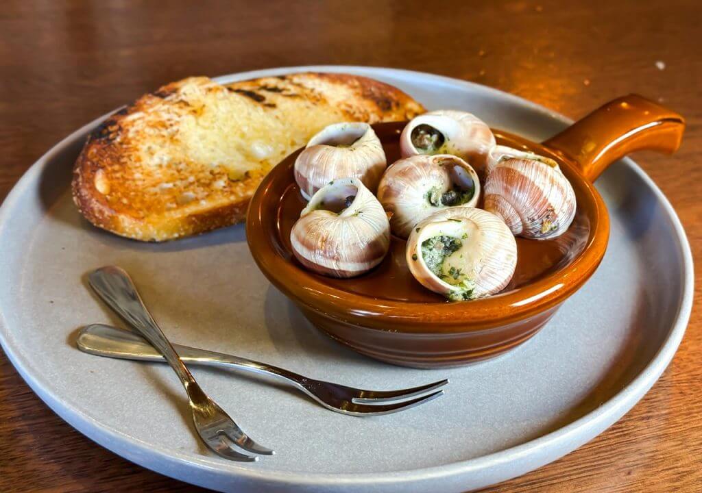 Village Crown Escargot with Snails, Garlic, Tarragon, Butter, White Wine, Parsley, and Toasted Sourdough Dish
